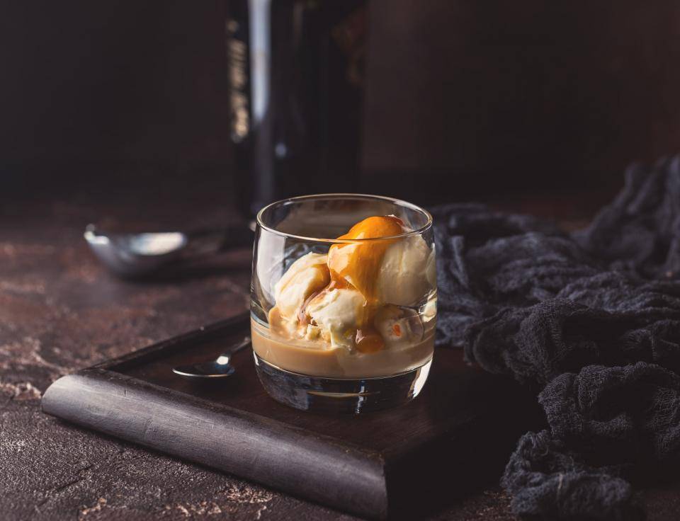 glass of ice cream topped with liquor 
