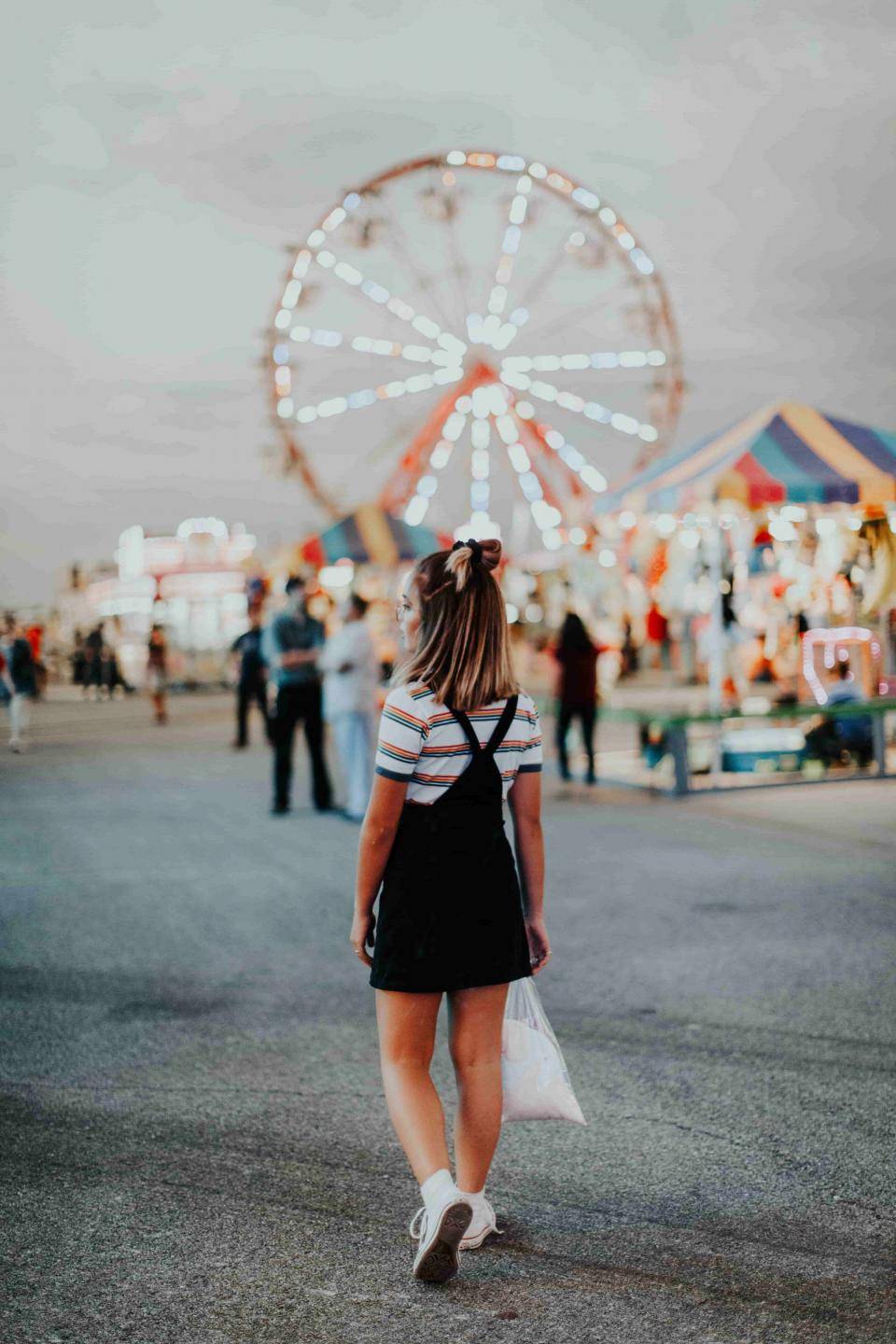 Teenager at retro fairground. Photo by Hannah Busing on Unsplash.