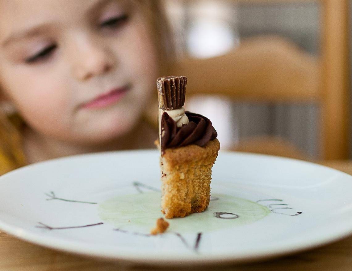 Little girl eating organic chocolate cupcake