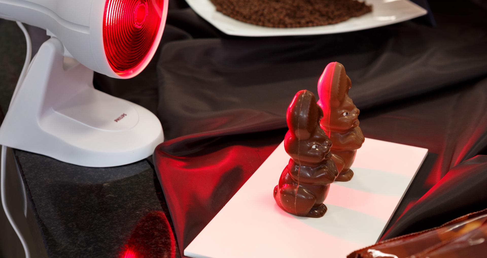 Thermotolerant chocolate bunnies in front of heat lamp