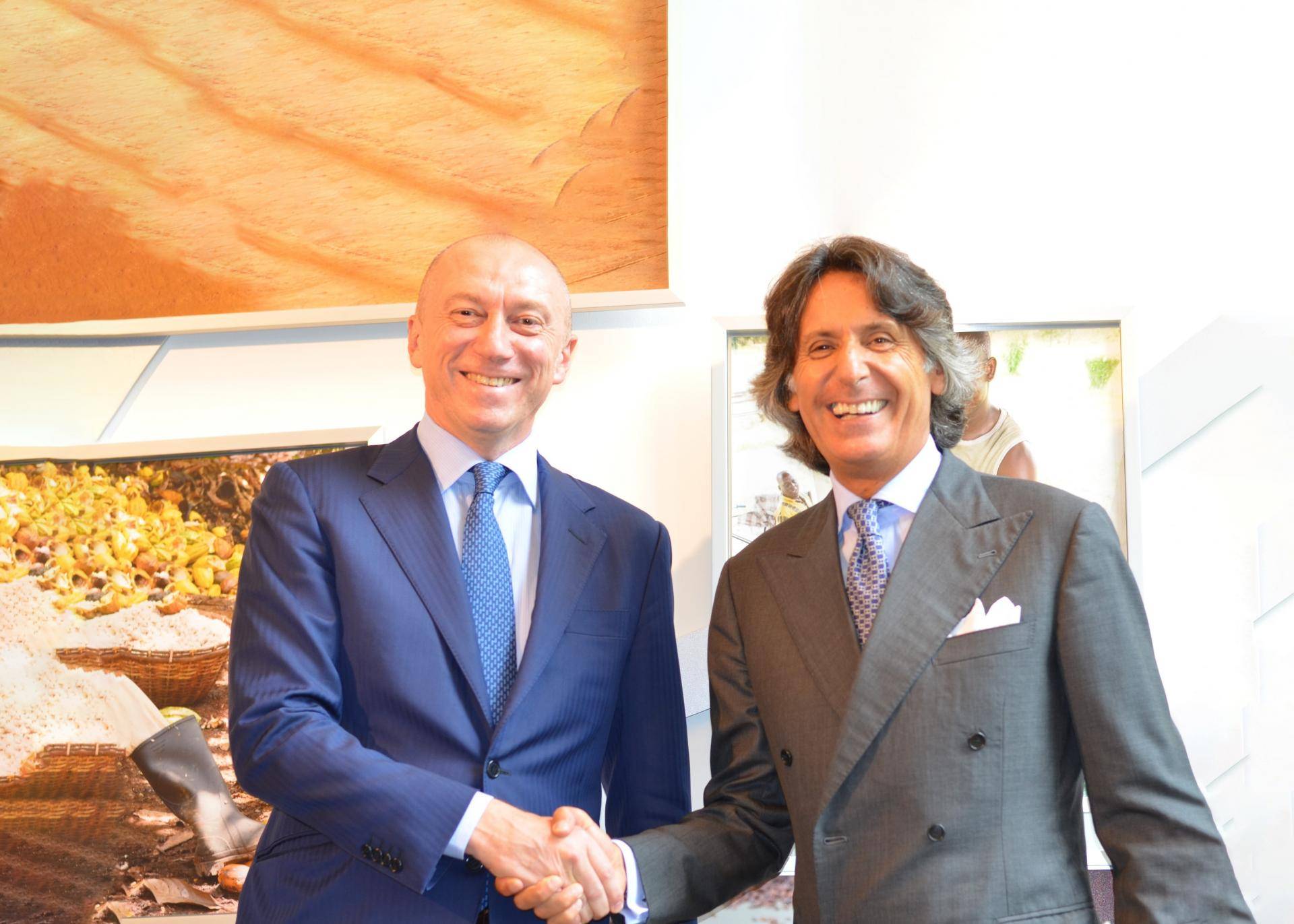 Massimo Garavaglia and Valerio D'Orsogna shake hands on the agreement.