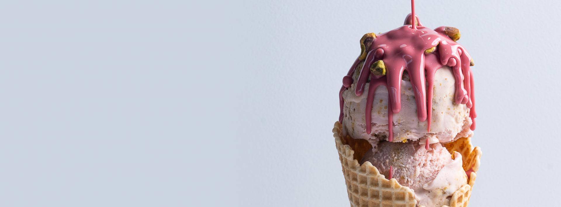 Colorful ice cream cone on a light background