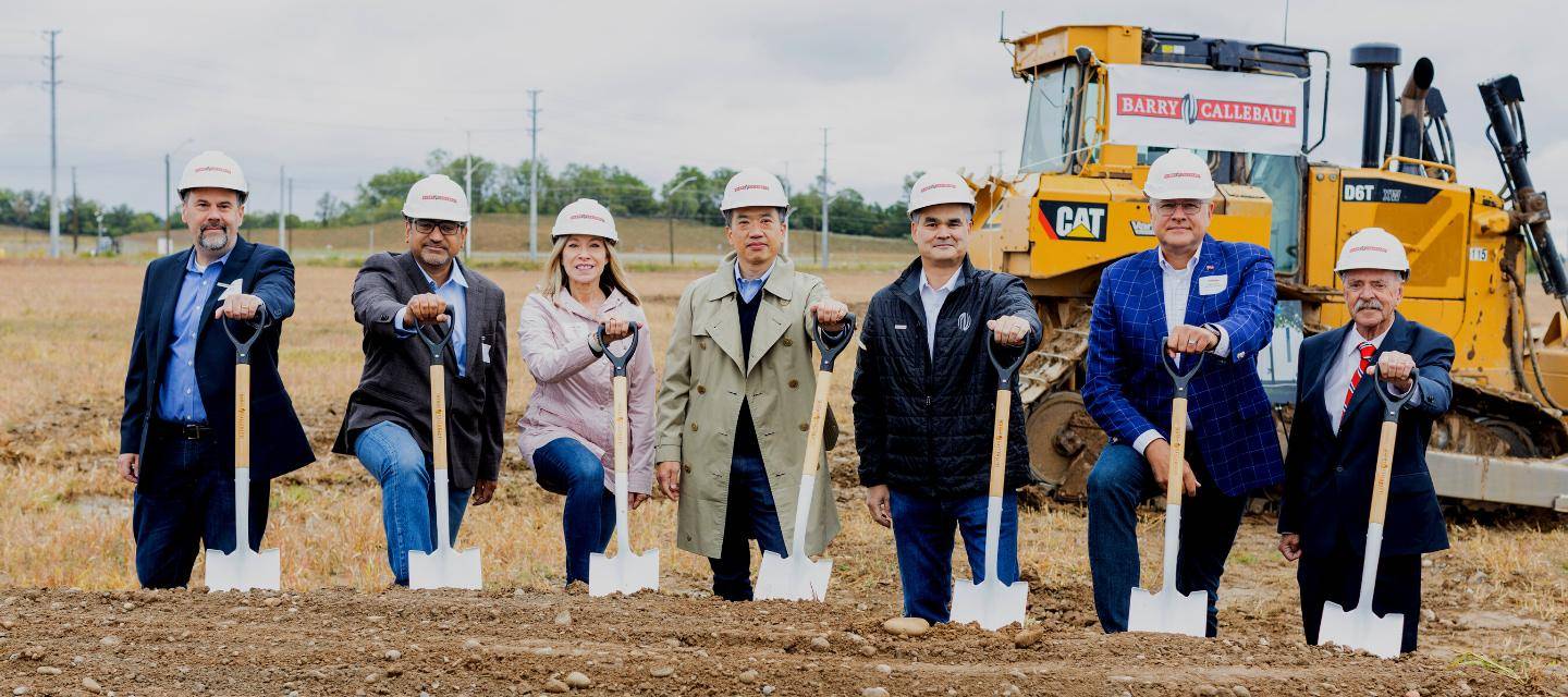 shovels lined up in front of construction vehicle