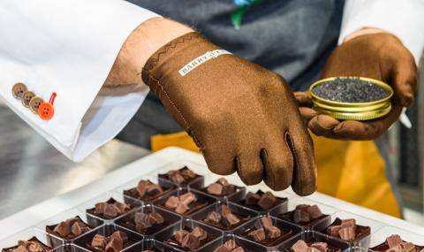 A BC Studio chef sprinkles black sea salt stop the nearly-completed bonbon cups