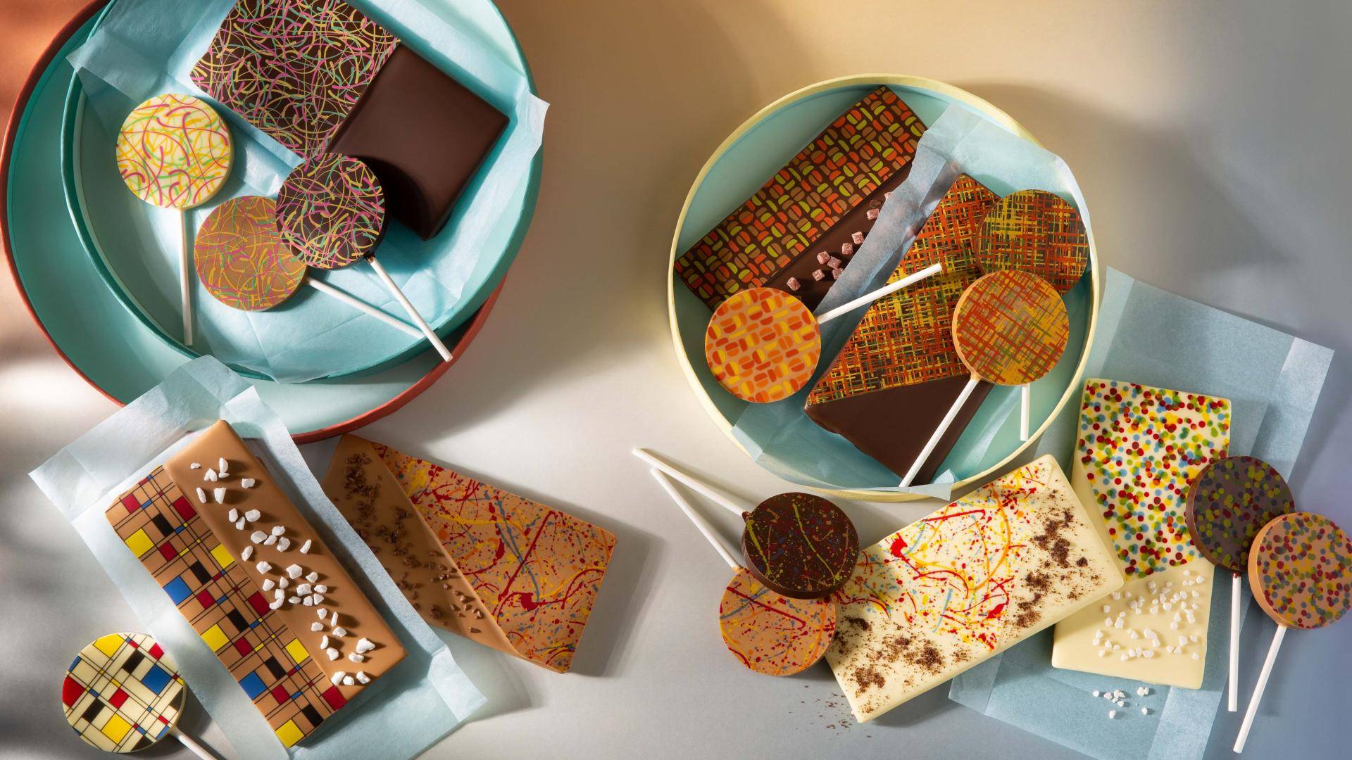 Chocolate tablets and lollipops decorated with transfers and sprinkles
