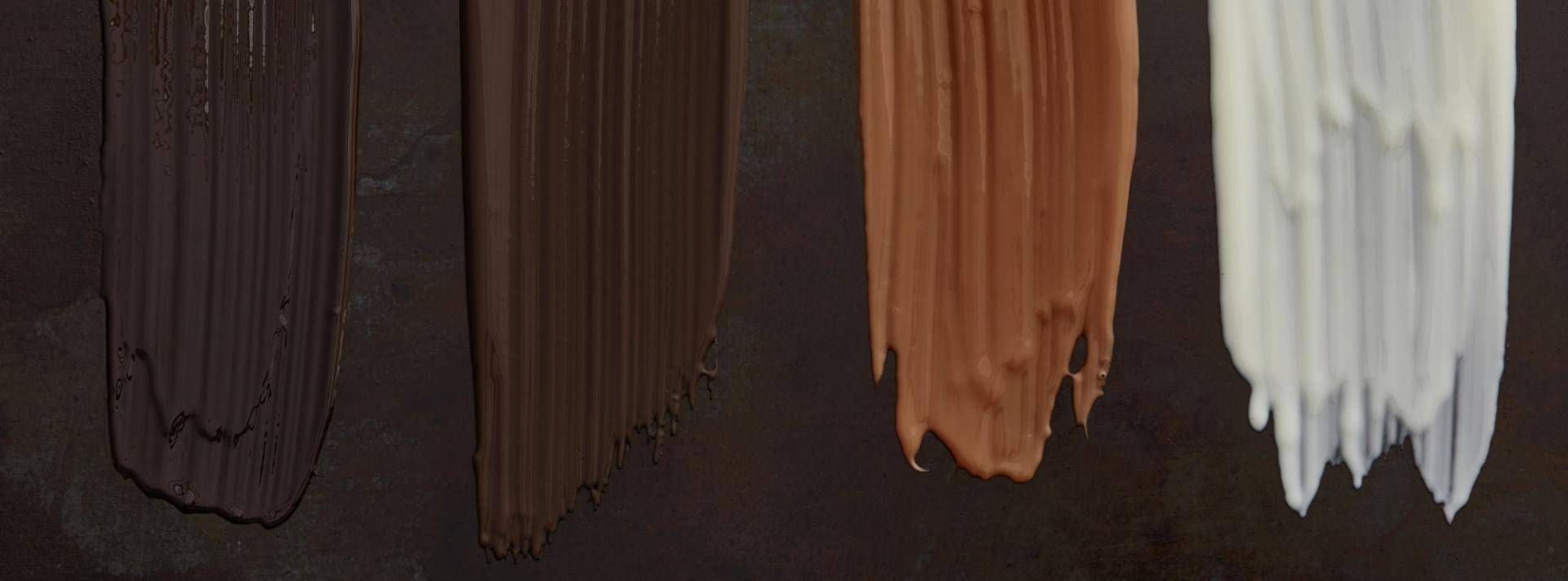 four swipes of chocolate on dark background
