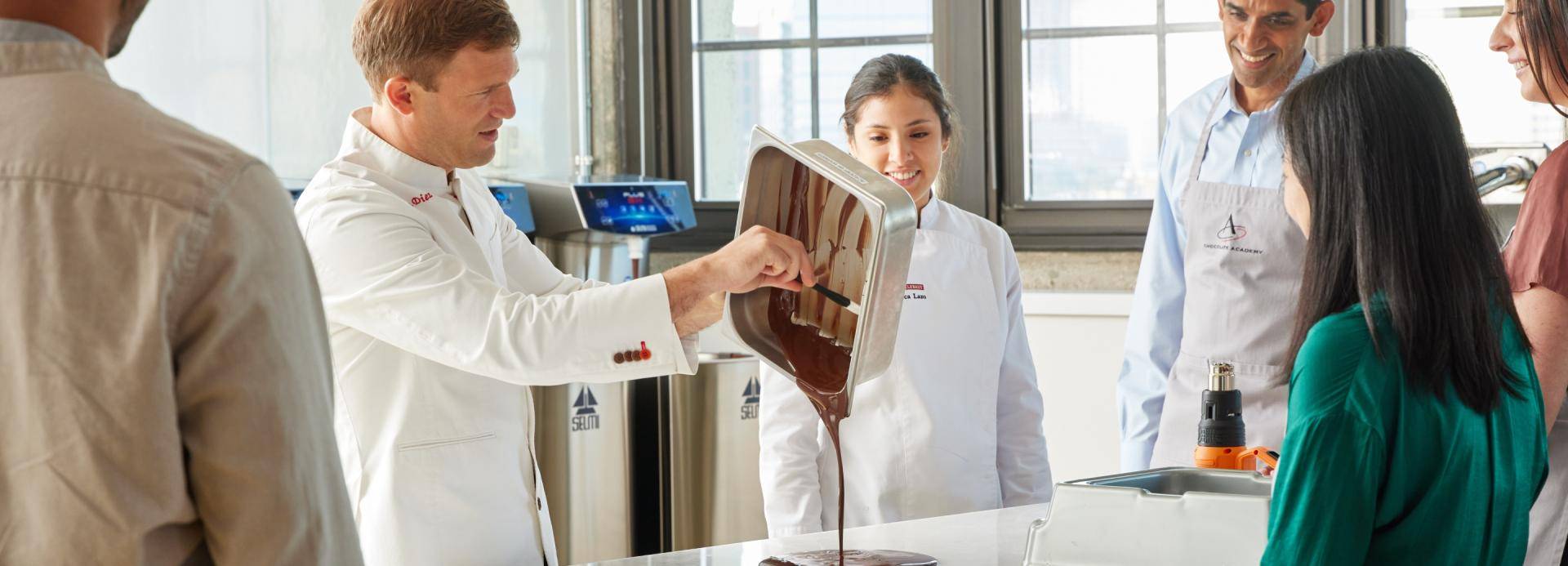 chefs working in kitchen with customers