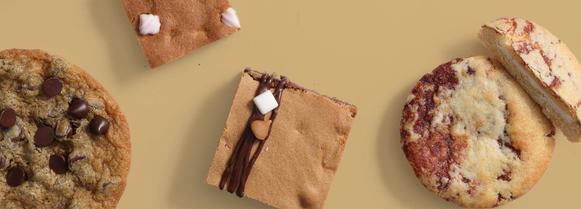 Cookies and brownies on a tan background