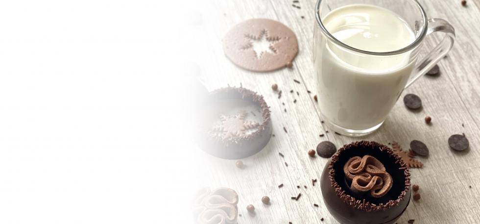 hot chocolate bombs next to a glass of milk