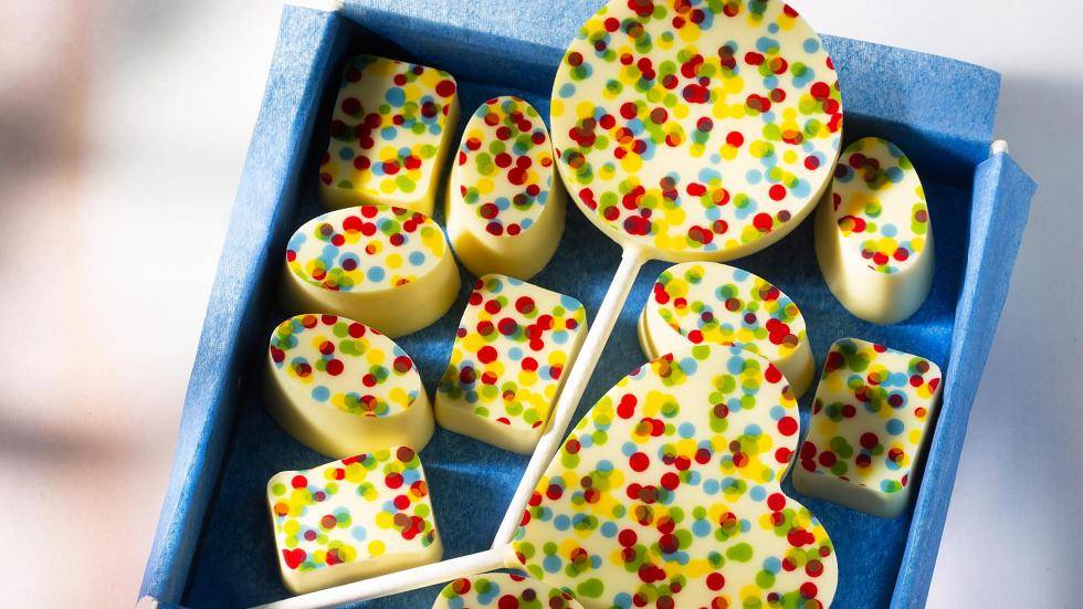 Chocolate pralines and lollipops with a colorful dotted print