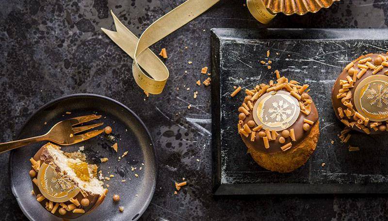 One-portion pastry with chocolate, apricot filling and caramel curls