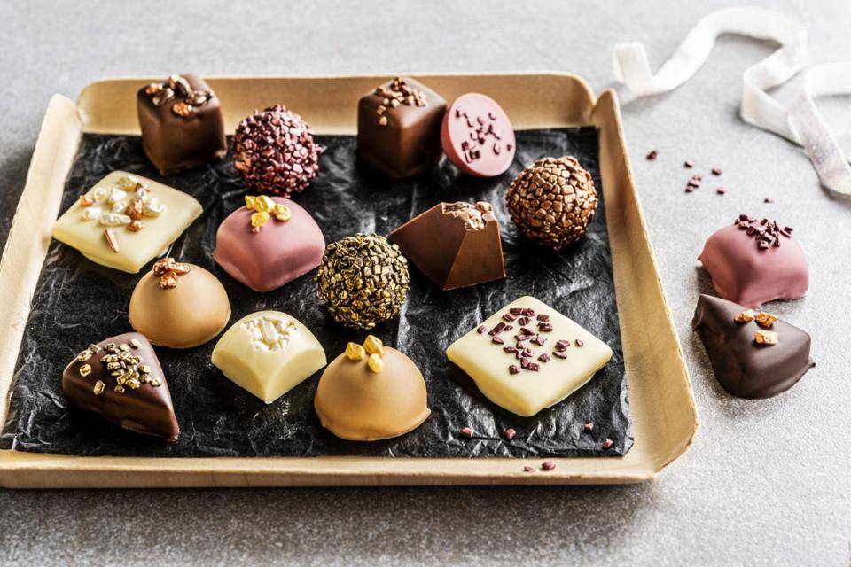 A selection of pralines with metallic chocolate sprinkles