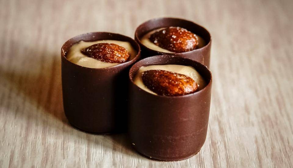 chocolate candies with almonds in center