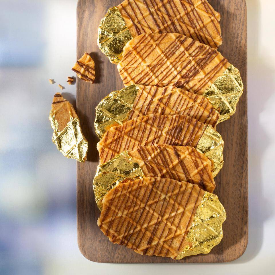 Thin waffels with a decoration of edible gold