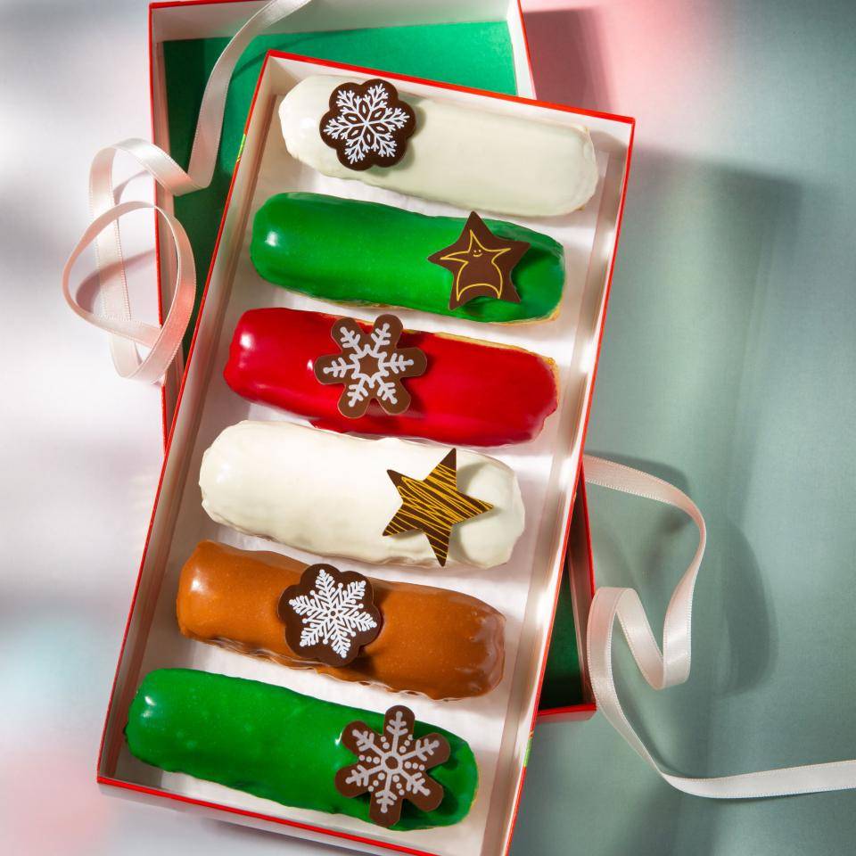 Christmas eclairs with colored glaze and various snowflake and star chocolate decorations