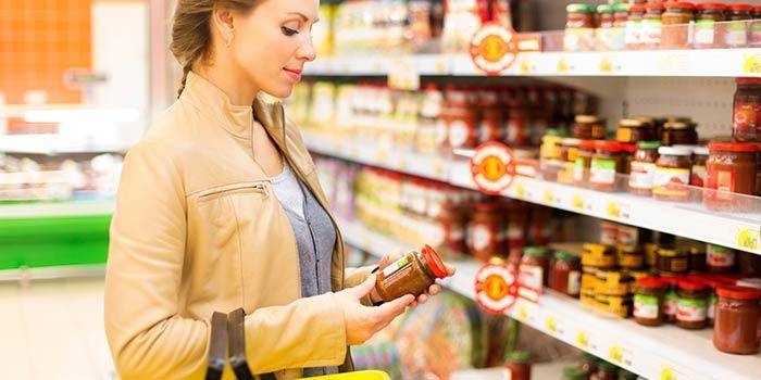 Millennial consumer reading labels of product