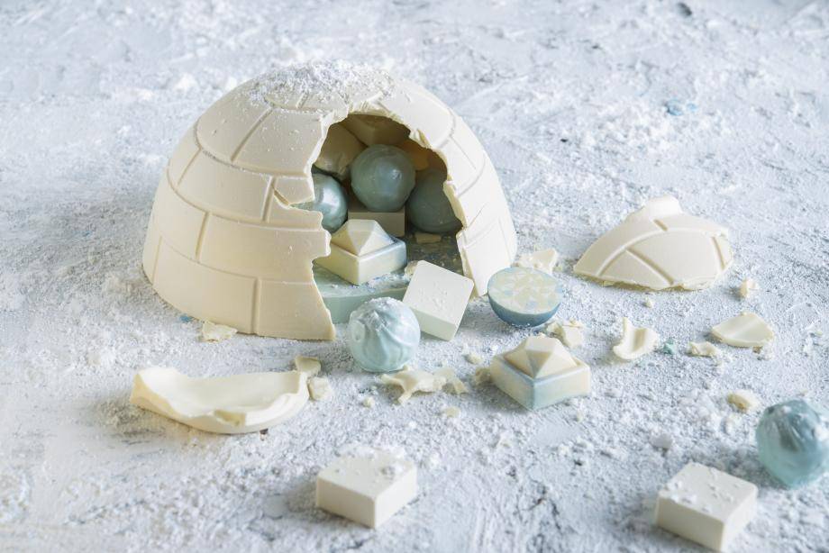 White chocolate, blue colored chocolate pralines, white igloo