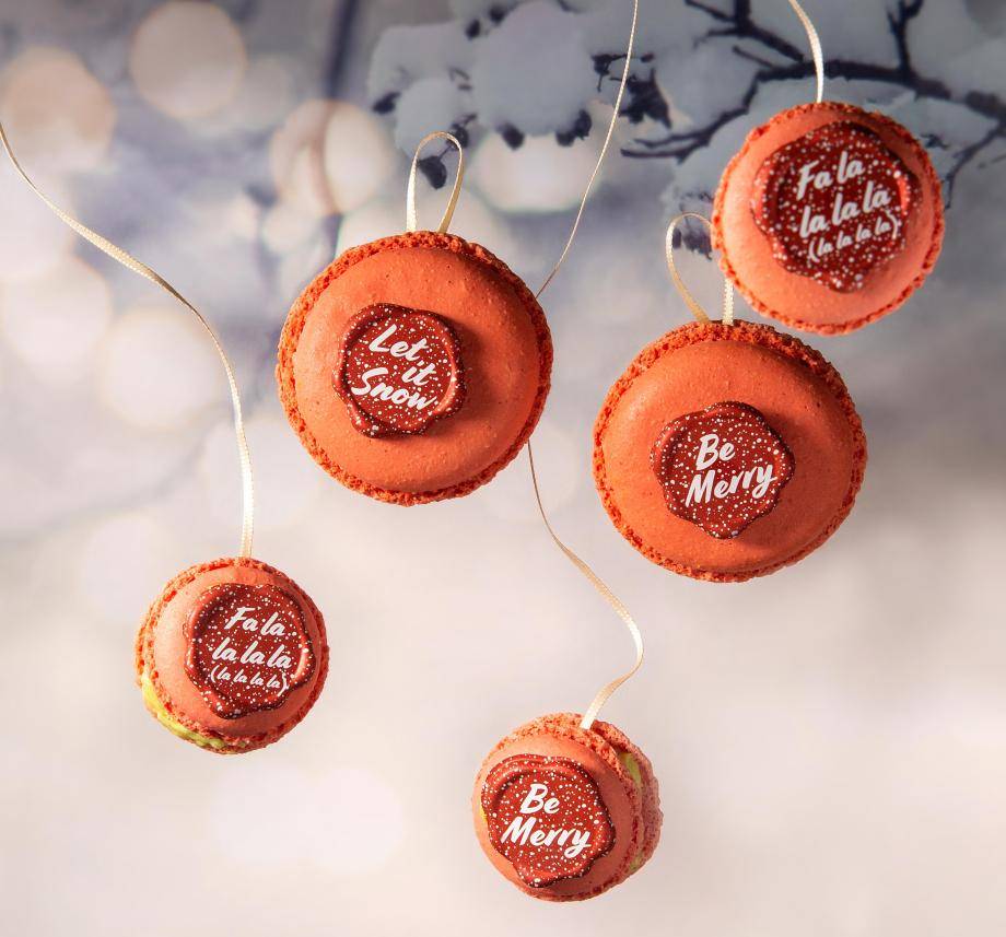 Red macarons, chocolate seals, Christmas slogans white snowflakes