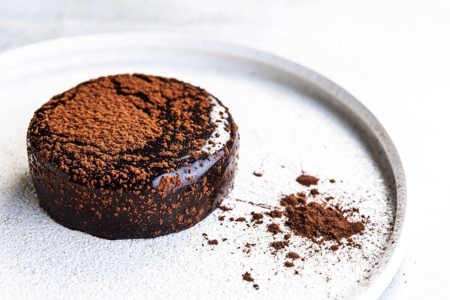 small chocolate cake on white plate
