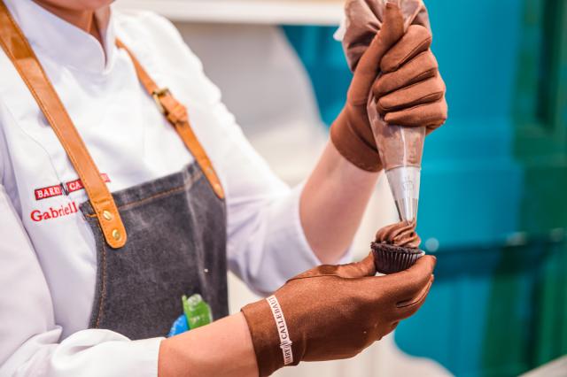 A BC Studio chef frosts a cupcake made with Bensdorp Natural Dark cocoa powder