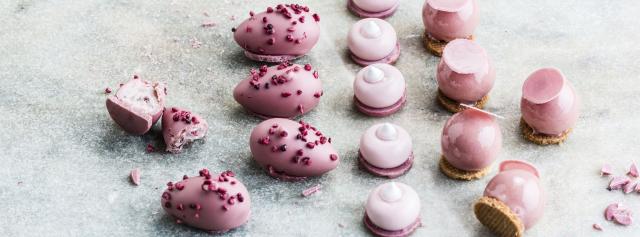 Ruby pralines with raspberry crispy whispers, creamy fillings and crunchy biscuit bottoming