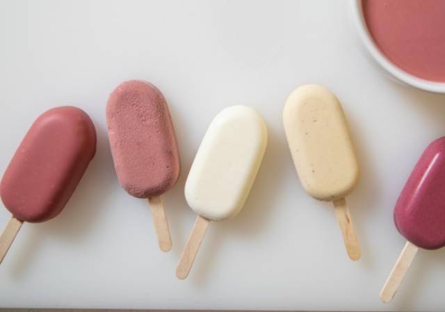 Ice cream bars dipped in ruby chocolate 