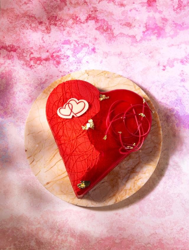 Heart shaped  pastry with red glaze and chocolate decoration