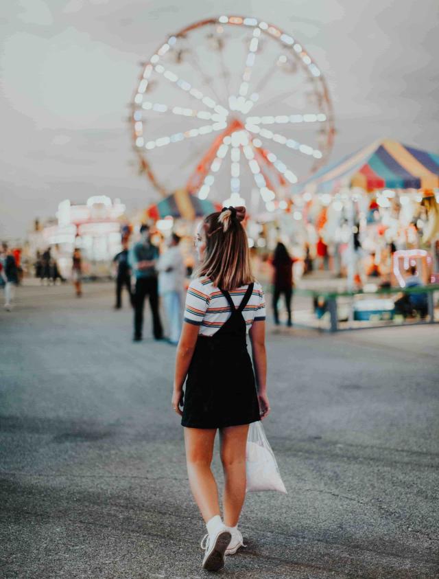 Teenager at retro fairground. Photo by Hannah Busing on Unsplash.