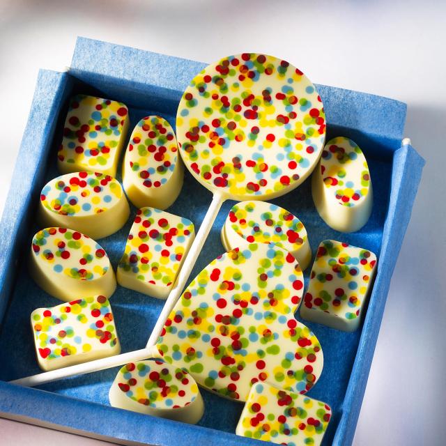 Chocolate pralines and lollipops with a colorful dotted print