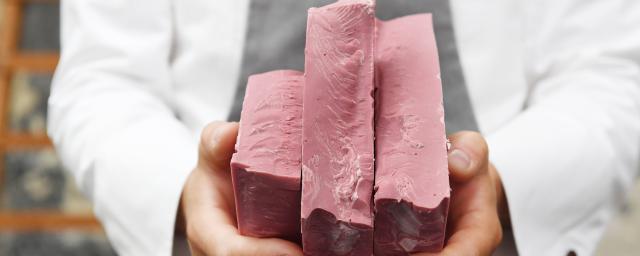 Chef holding 3 blocks of Ruby chocolate