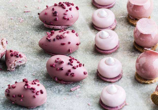 Ruby pralines with raspberry crispy whispers, creamy fillings and crunchy biscuit bottoming
