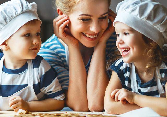 Happy mom and kids baking together