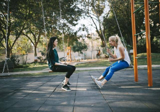 two young women on a swing set