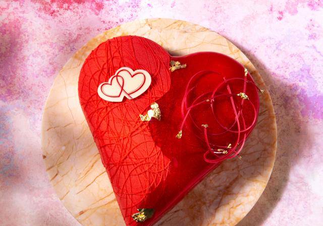 Heart shaped  pastry with red glaze and chocolate decoration