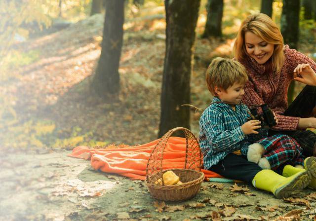 mother and son sitting in nature together